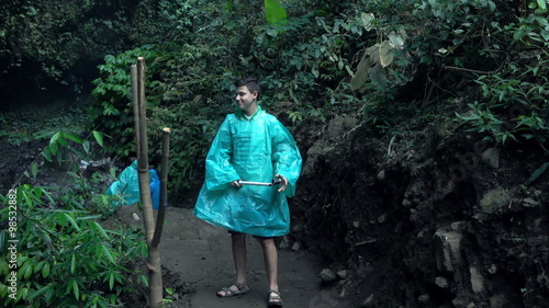 Young boy taking photo using selfie stick in jungle, super slow motion 120fps
