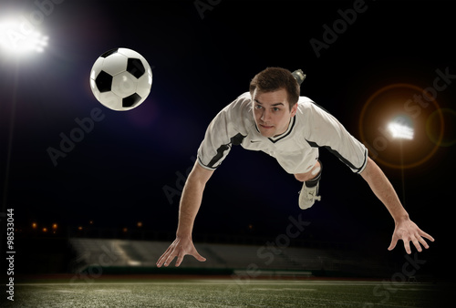 Soccer Player hitting the ball