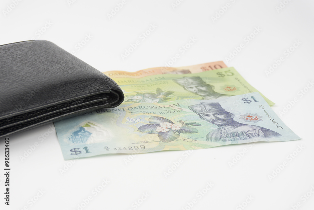 Black leather wallet with brunei money on white background Black leather wallet with brunei money on white background