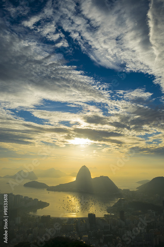 Scenic Rio de Janeiro Brazil golden sunrise over Guanabara Bay with a misty skyline silhouette of Sugarloaf Mountain