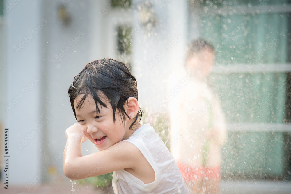 Asian children washing car Asian children washing car