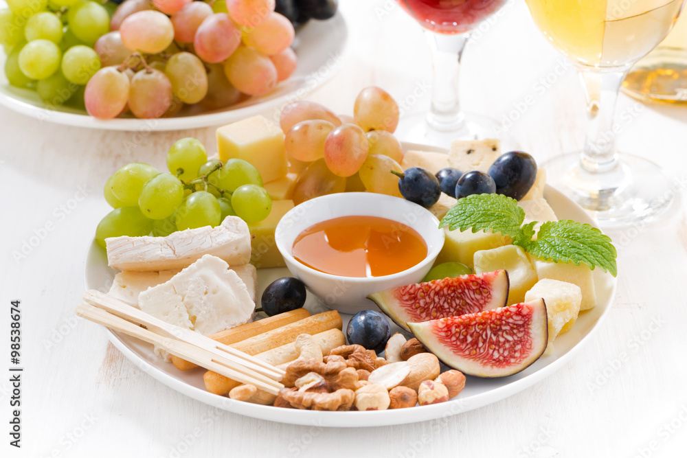 cheeses, fruits, wine and snacks cheeses, fruits, wine and snacks
