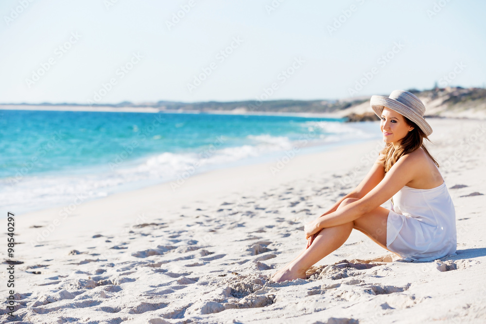 Young woman sitting on the beach Young woman sitting on the beach