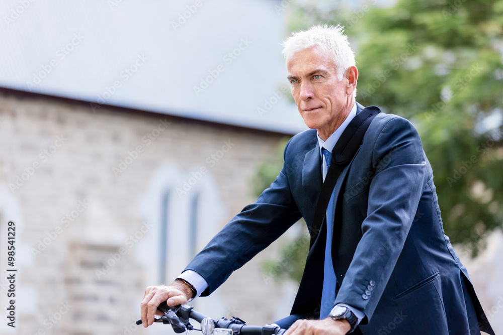 Fototapeta premium Successful businessman riding bicycle