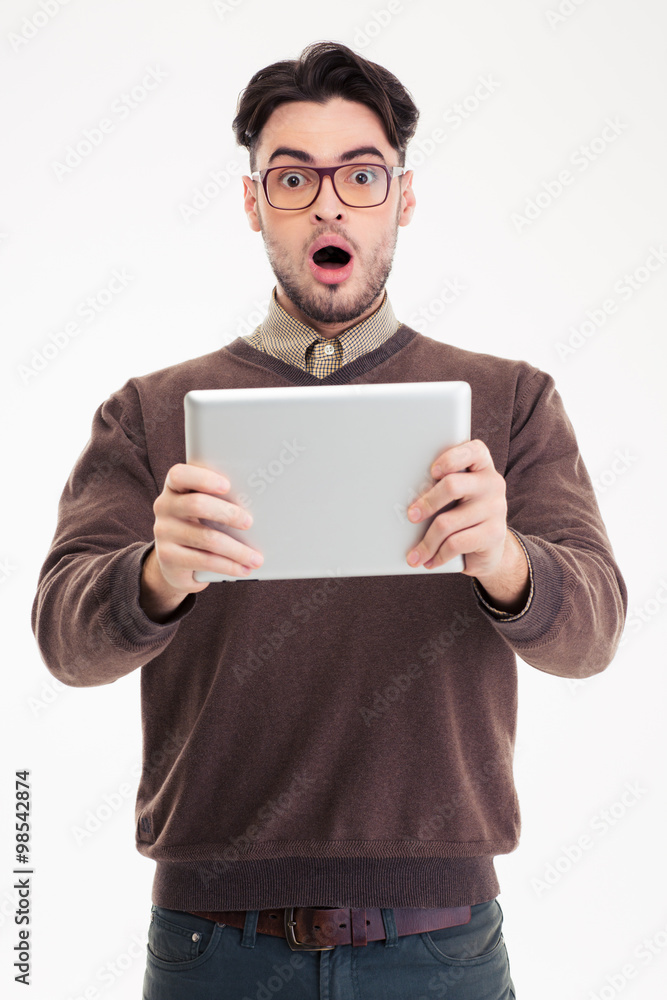 Shocked man using tablet computer Shocked man using tablet computer