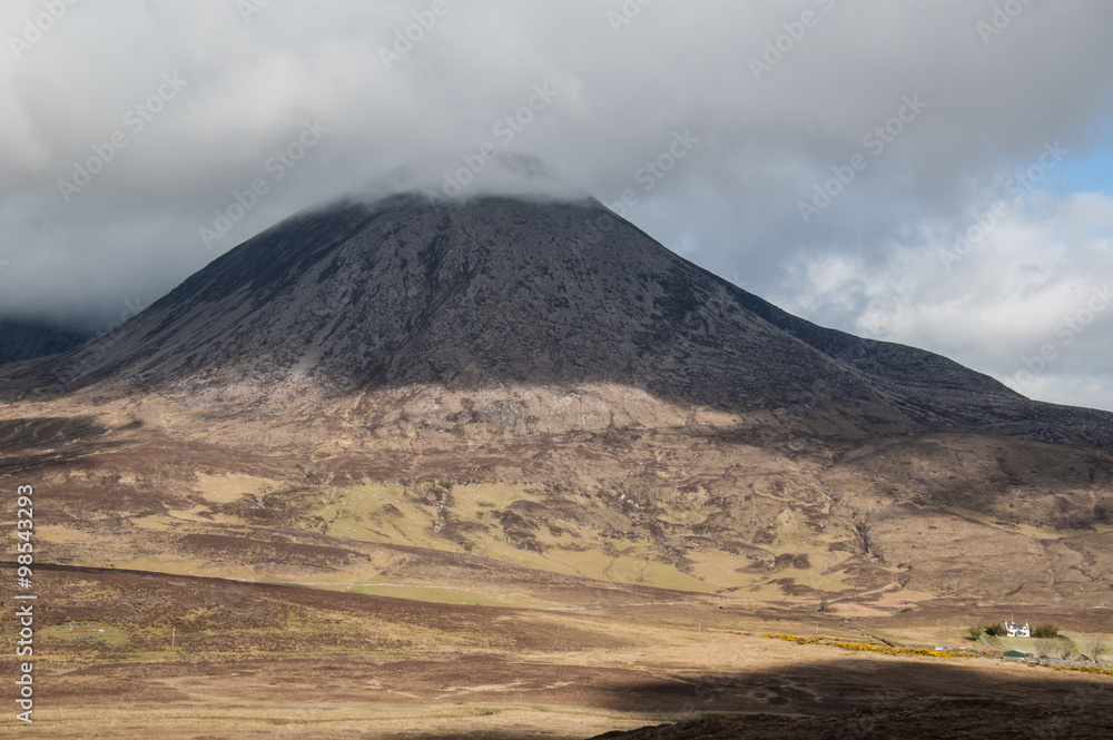 Barren Scottish mountain with the top covered in clouds.