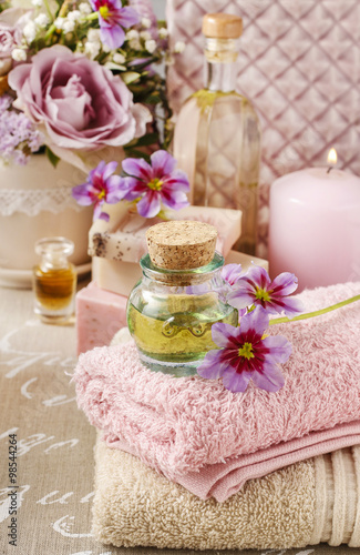 Bottle of essential oil and soft towels
