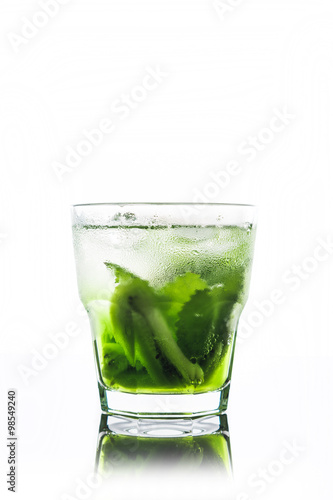 Green cocktail with kiwi slices isolated on white
