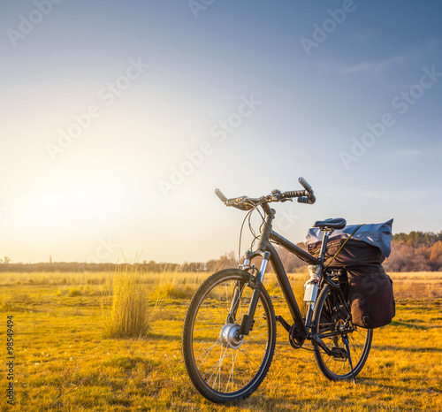 bicycle among a prairie at the sunset