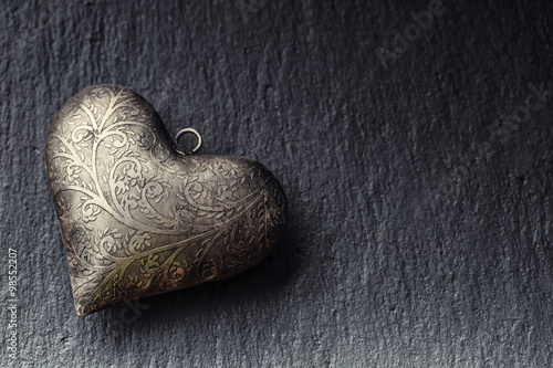 Valentine time. Valentine Metal heart on a granite board. Valentine's two sil...