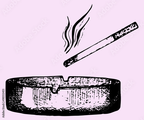 cigarette in an ashtray isolated over a pink background with a clipping path