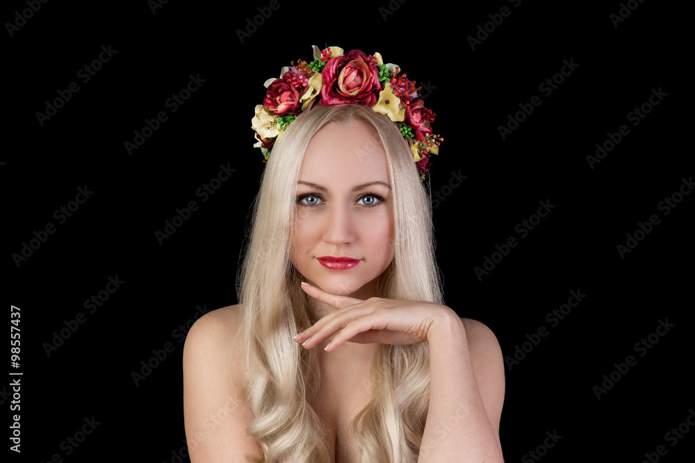 Beautiful model in flower crown with hand near face
