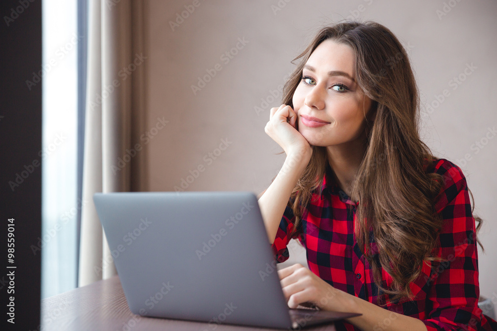 Smiling pretty woman using laptop computer Smiling pretty woman using laptop computer