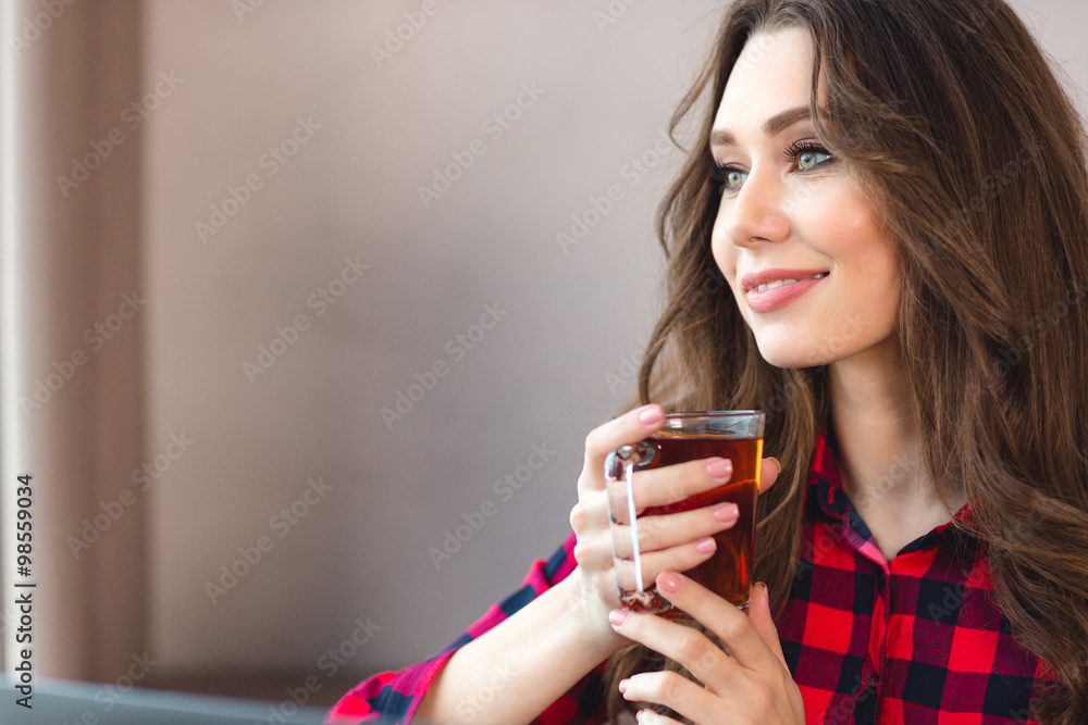 Thoughtful happy woman holding glass with tea Thoughtful happy woman holding glass with tea