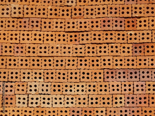 Many clay bricks stack on ground