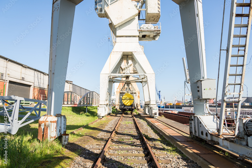 Historical harbor cranes and railway carriage at the Port Museum at shed 50a in the harbor of Hamburg district Kleiner Grasbrook. Here the Port Museum has an exhibit of old harbor equipment Historical harbor cranes and railway carriage at the Port Museum at shed 50a in the harbor of Hamburg district Kleiner Grasbrook. Here the Port Museum has an exhibit of old harbor equipment
