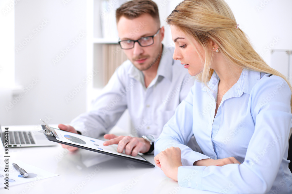 Two successful business partners working at meeting in office Two successful business partners working at meeting in office