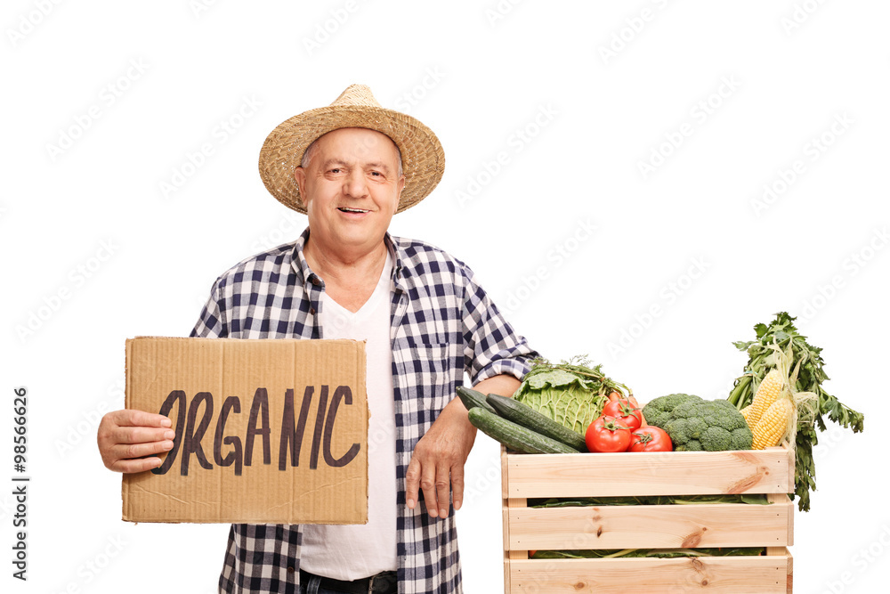 Farmer posing with a crate of organic vegetables