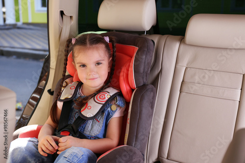 Cute little girl sitting in...