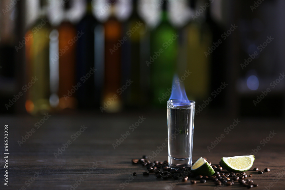 Burning cocktail with lime and coffee beans on table in a bar Burning cocktail with lime and coffee beans on table in a bar