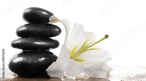 Spa stones with lily  isolated on white