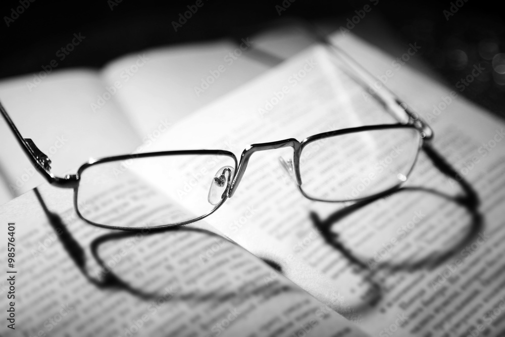 Eye glasses on open book, close up Eye glasses on open book, close up