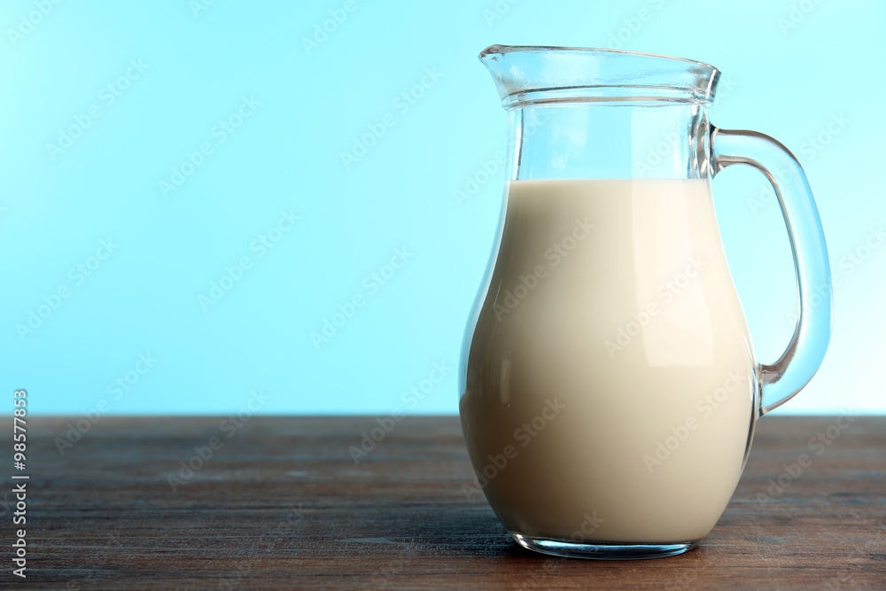 Jar of milk on table on blue background Jar of milk on table on blue background