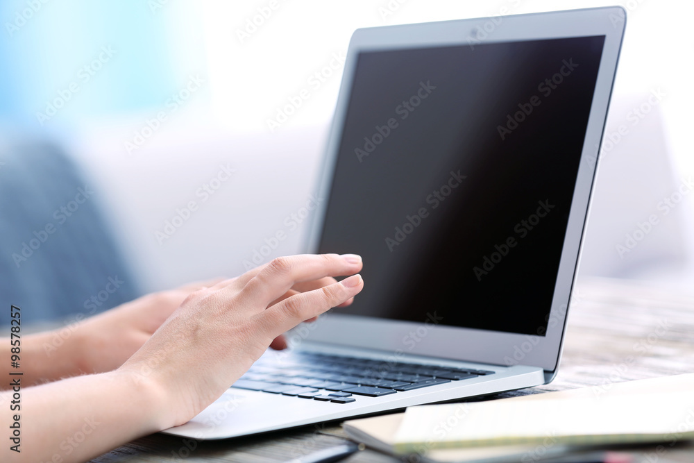 Woman sitting at the table and working with laptop Woman sitting at the table and working with laptop