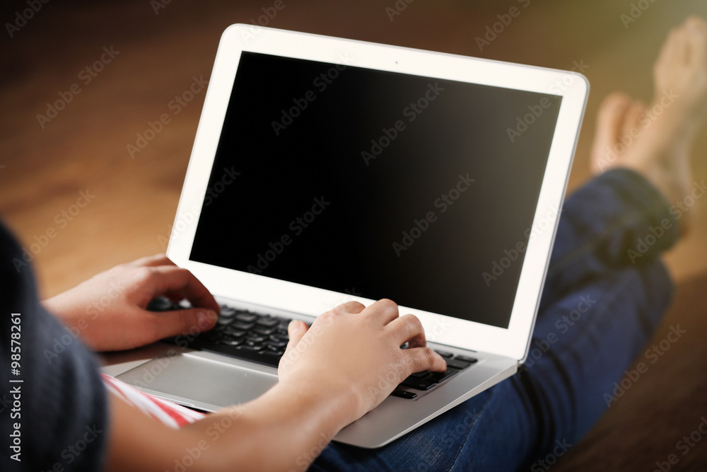Woman sitting on the floor and working with a laptop Woman sitting on the floor and working with a laptop
