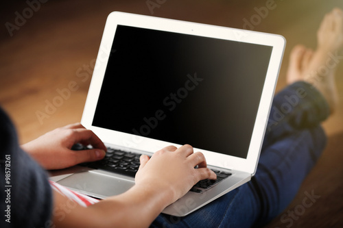 Woman sitting on the floor and working with a laptop