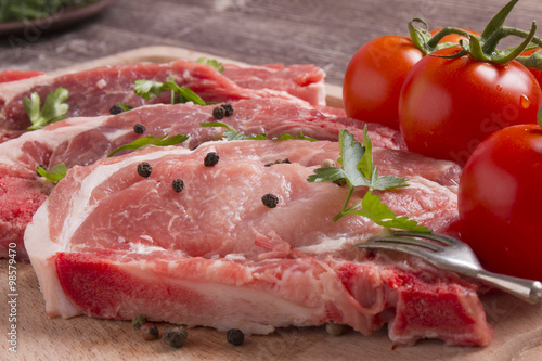 Fresh raw pork chop meat on cutting board