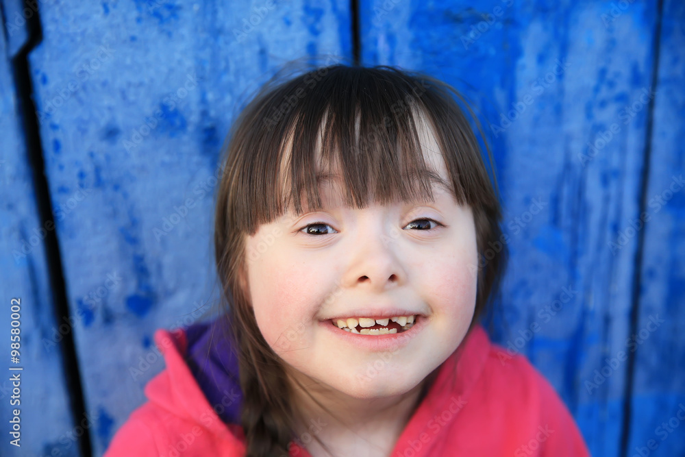 Young girl smiling on background of the blue wall. Young girl smiling on background of the blue wall.