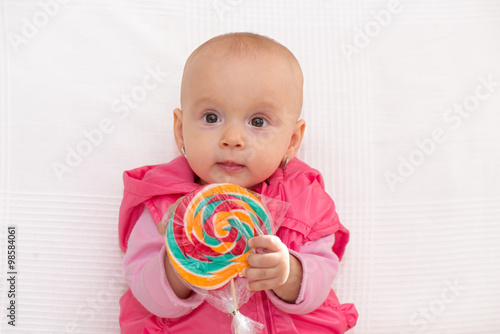 Baby girl portrait with lollipop