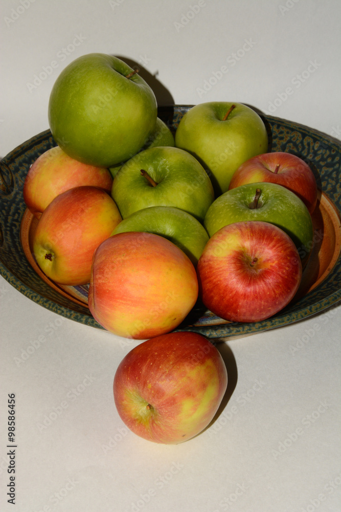 Granny Smith and Fuji apples on ceramic handcrafted platter Granny Smith and Fuji apples on ceramic handcrafted platter