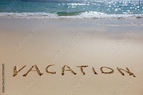 Vacation written on beach