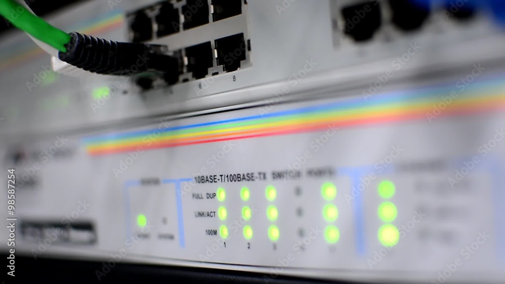 Networking switch with active blinking led lights and patch cable plugs