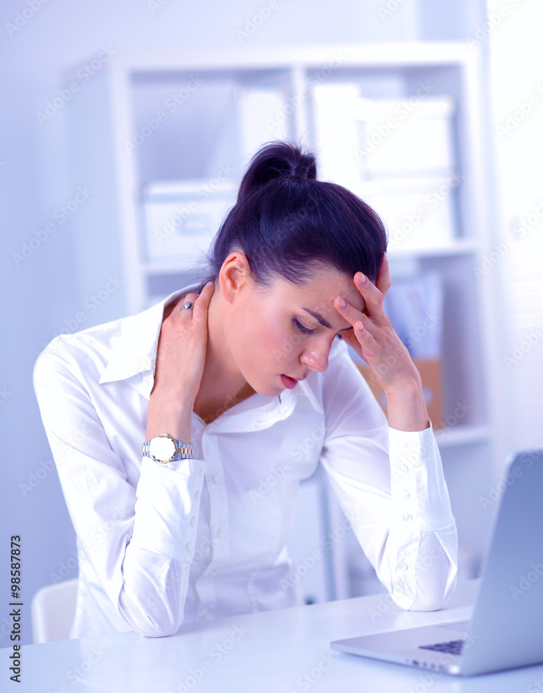 Stressed businesswoman sitting at desk in the office Stressed businesswoman sitting at desk in the office