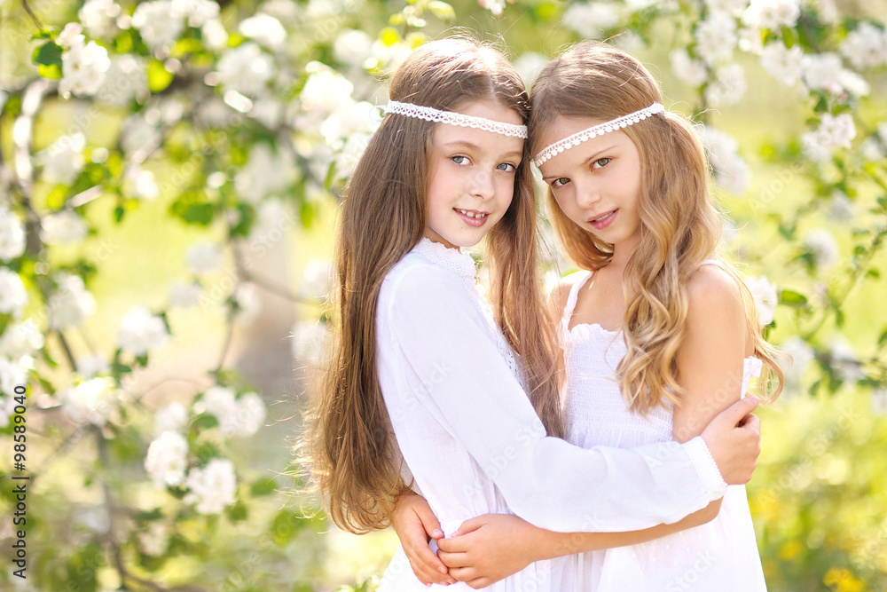 portrait of two girls of girlfriends on a summer nature portrait of two girls of girlfriends on a summer nature