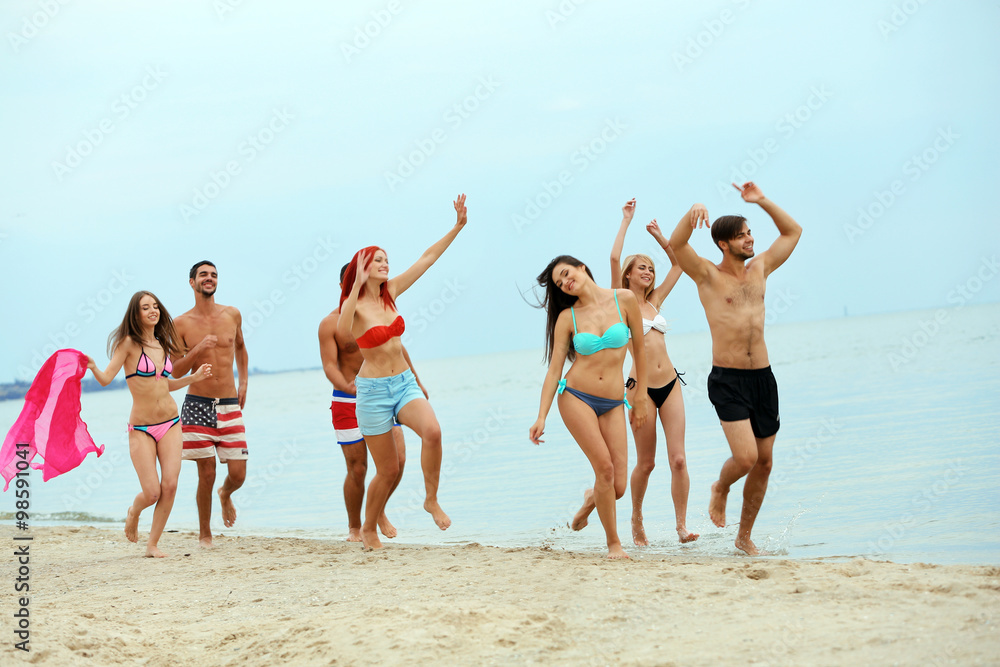 Beautiful young people having fun on beach