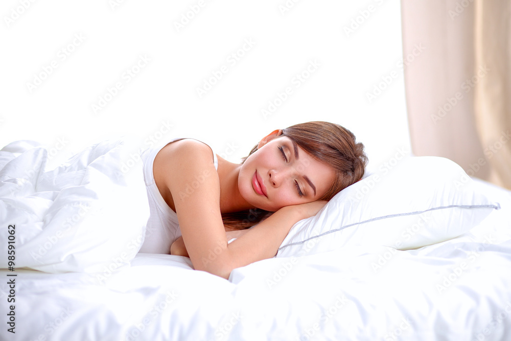 Beautiful girl sleeps in the bedroom, lying on bed Beautiful girl sleeps in the bedroom, lying on bed