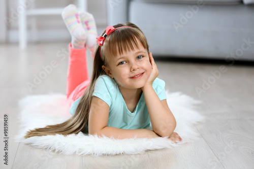 Little cute girl lying on c...