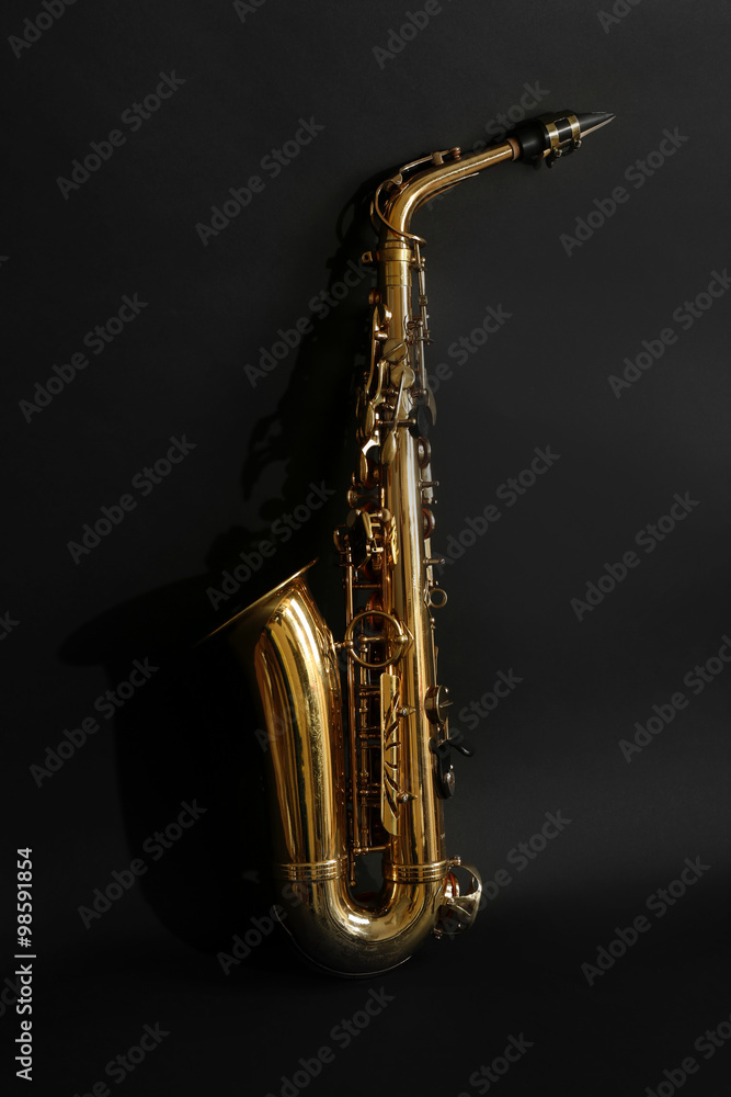 Obraz premium Beautiful golden saxophone on black background