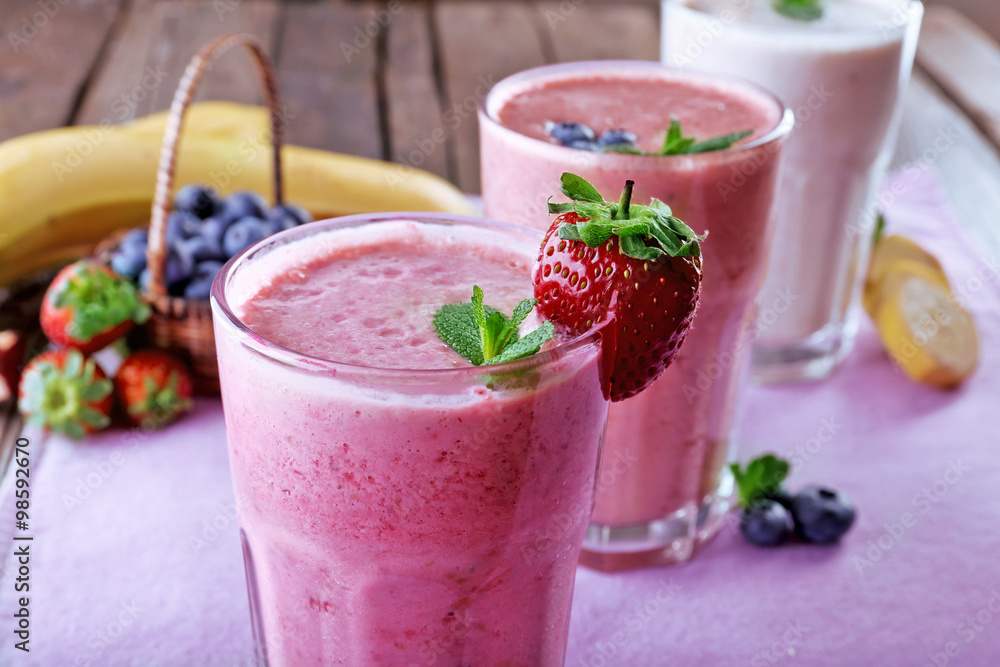 Glasses of fresh cold smoothie with fruit and berries, on the table, close-up Glasses of fresh cold smoothie with fruit and berries, on the table, close-up