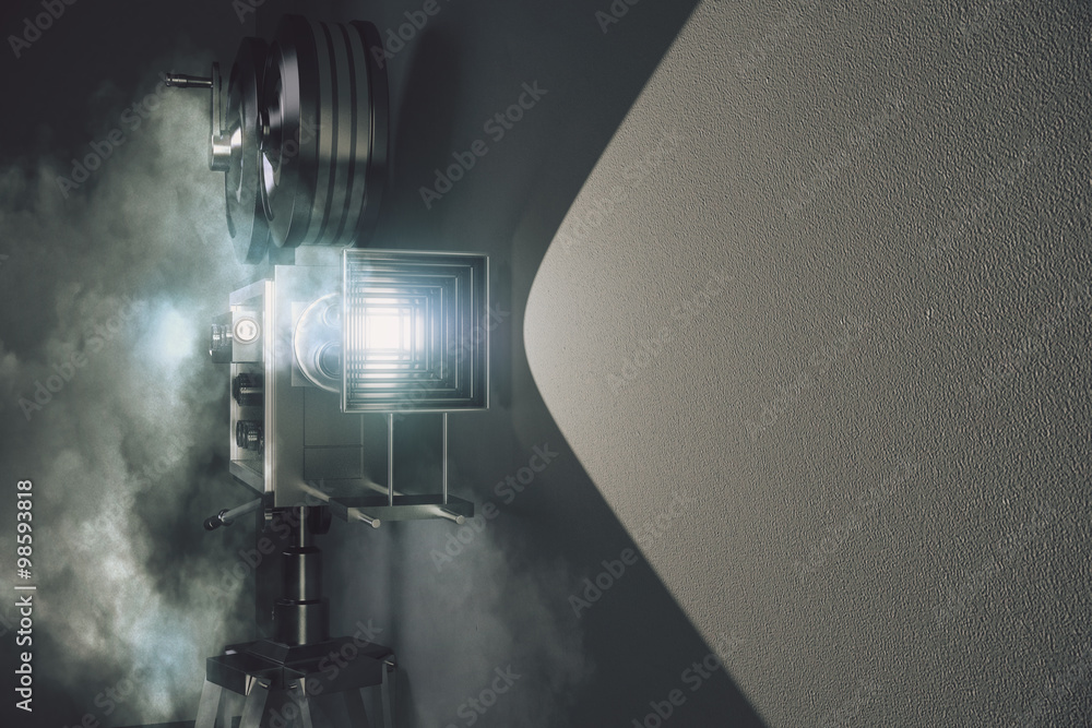Fototapeta premium Vintage movie camera in the fog and grey wall