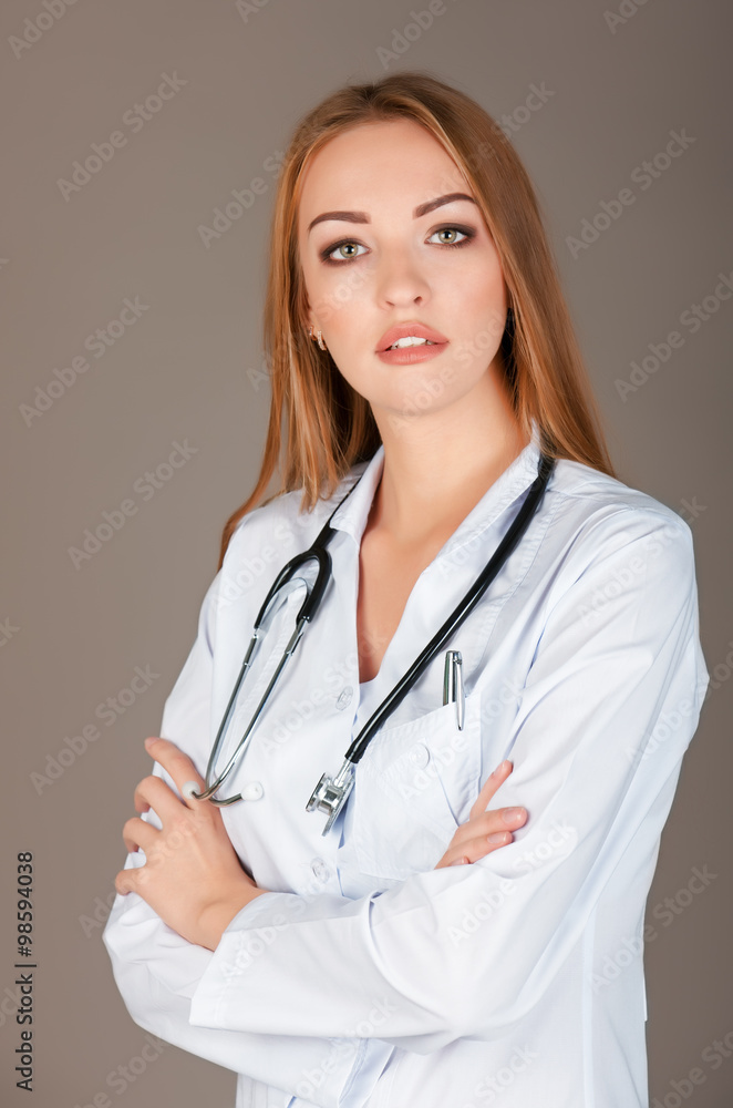 medical doctor woman with stethoscope. Isolated over gray backgr medical doctor woman with stethoscope. Isolated over gray backgr