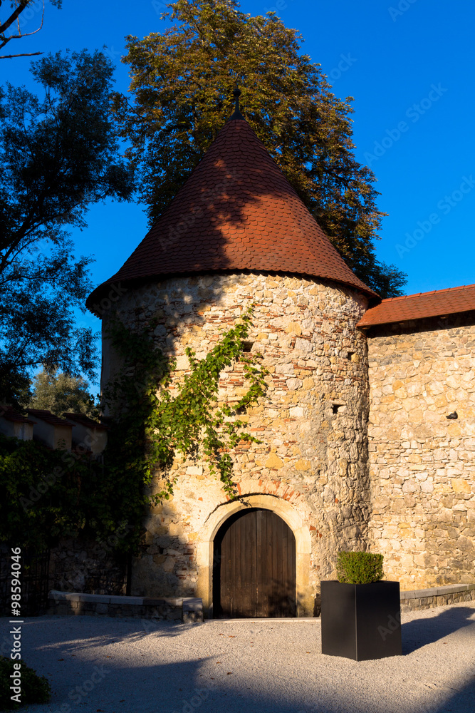 Otocec, Slovenia - September 12, 2015. Otocec castle tower in the rays of evening sun.