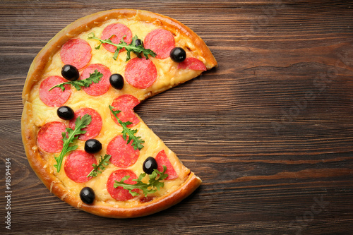 Without-one-piece tasty pizza  on wooden background, close up