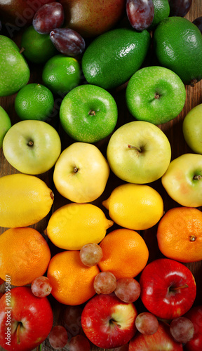 Fruits on wooden background, top view
