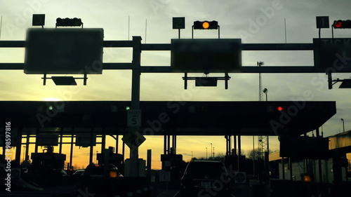 A driver's perspective of slowly passing through a turnpike's toll plaza.
 photo