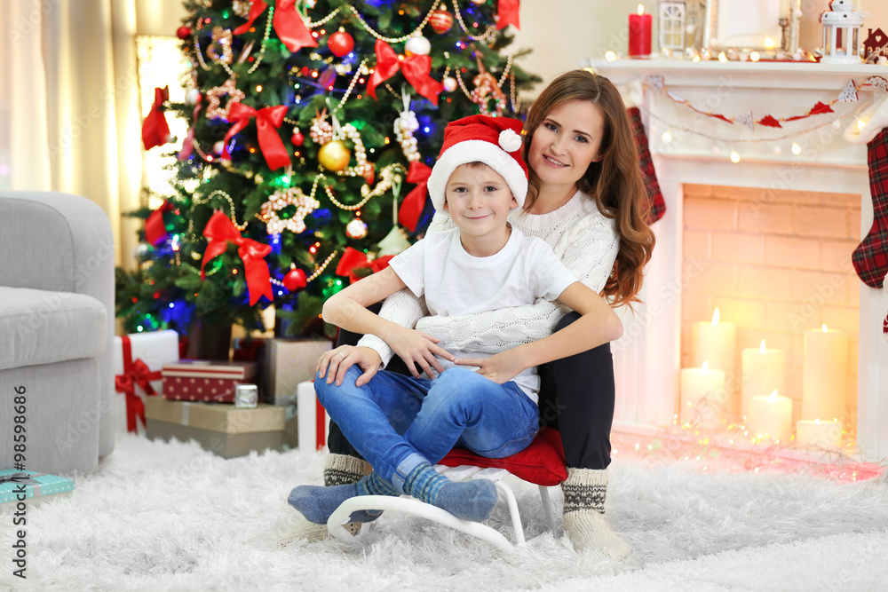 Mother with son near Christmas tree Mother with son near Christmas tree